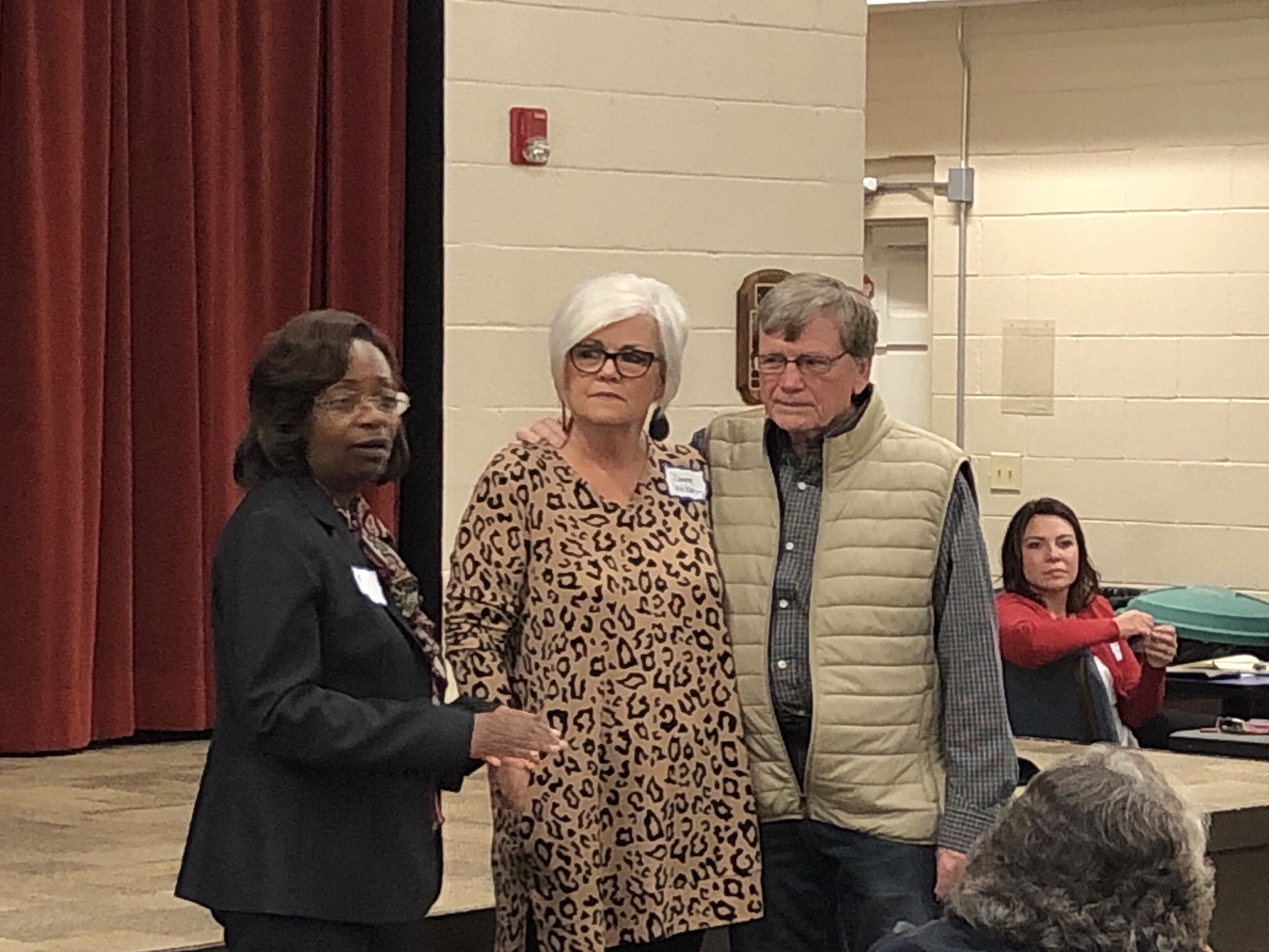 Photo of June Wood speaking as Johnny Wilson and his wife Donna look on (staff photo)