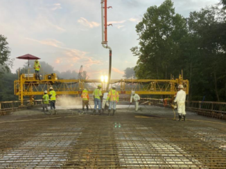 Photo shows work crews pouring concrete at new bridge on state route 81, August 2021 (Georgia DOT photo).