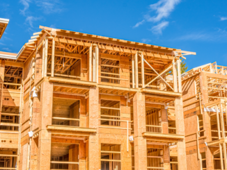 Photo shows wood framing for new apartments under construction (stock photo).