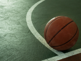 Photo showing a basketball on the edge of a basketball court (stock photo).
