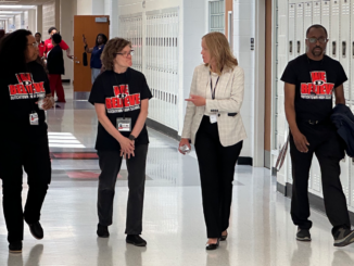 Photo shows HCS Superintendent David and three Dutchtown school employees walking down a hallway (Clayton Carte photo).