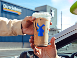 Photo shows an iced coffee being passed to a customer outside of a Dutch Bros Coffee (company photo).