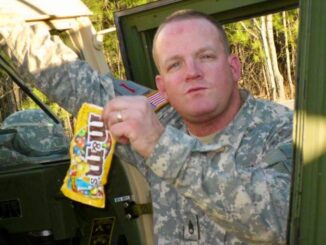 Sgt. 1st Class John Beale, then Staff Sgt., poses with his favorite candy while seating in a Georgia Army National Guard armored humvee. Beale joined the GAARNG in 2004 as a calvary scout after previously serving on active duty from 1989 to 1995.